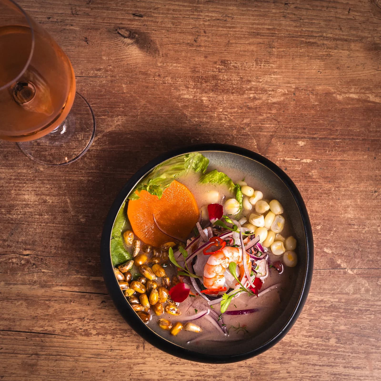 Top-down Pachamama ceviche with sweet potato, choclo, cancha and red onion