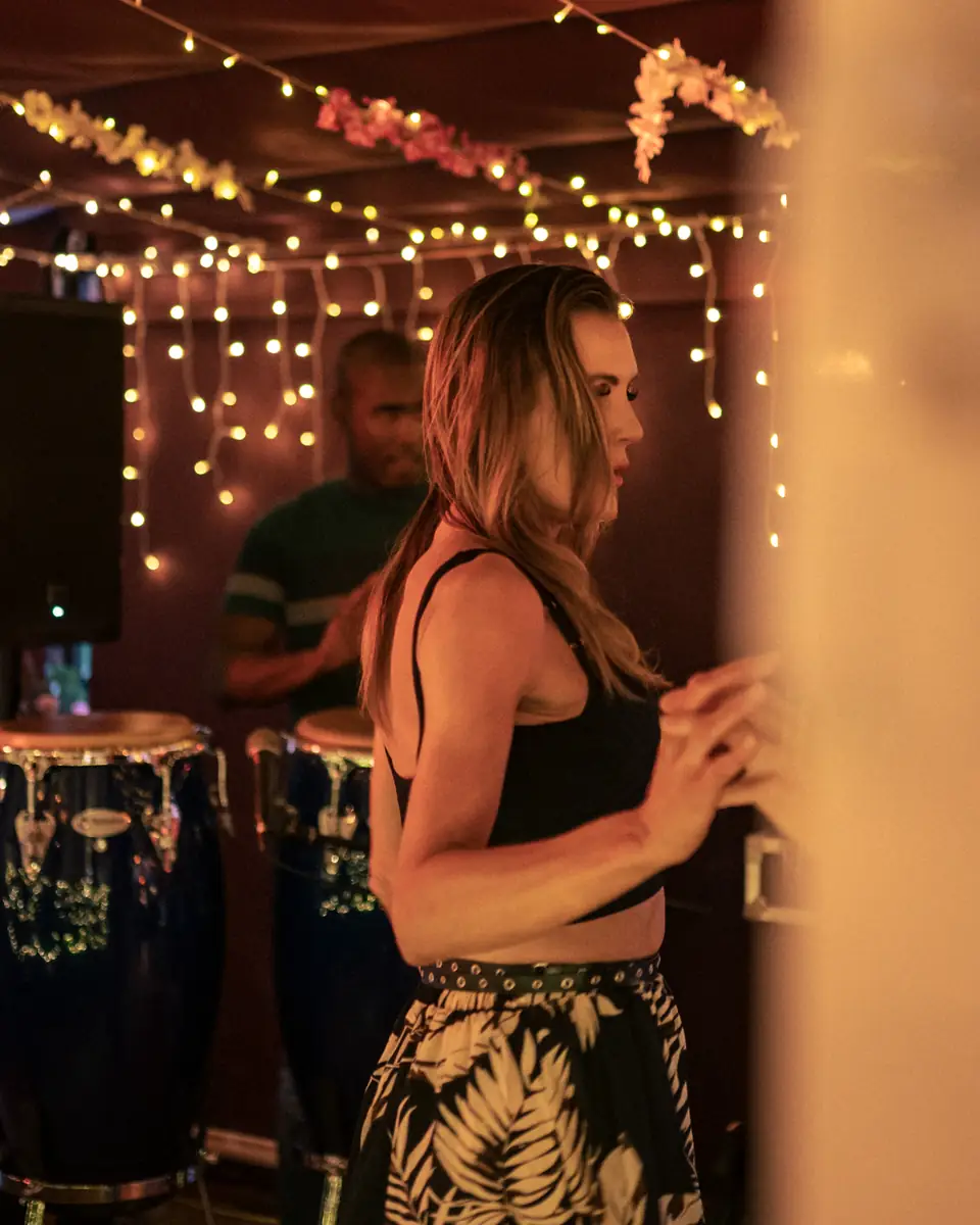 A guest dancing under the string lights at Pachamama