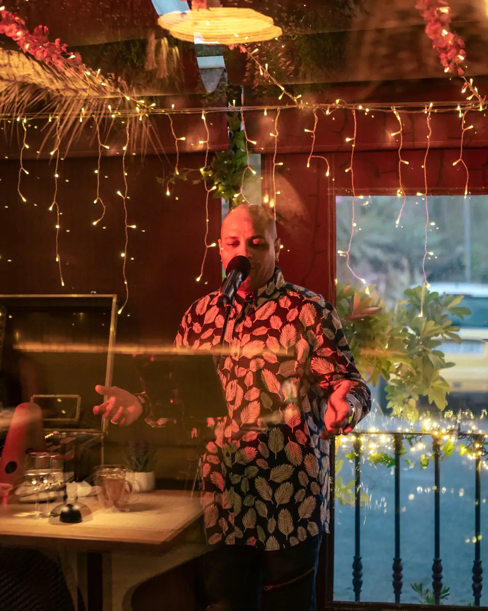 A singer performing between the tables at Pachamama