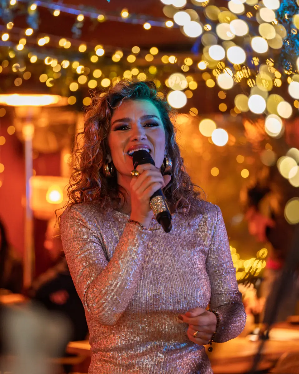 A singer in a sequinned dress performing on the Pachamama terrace