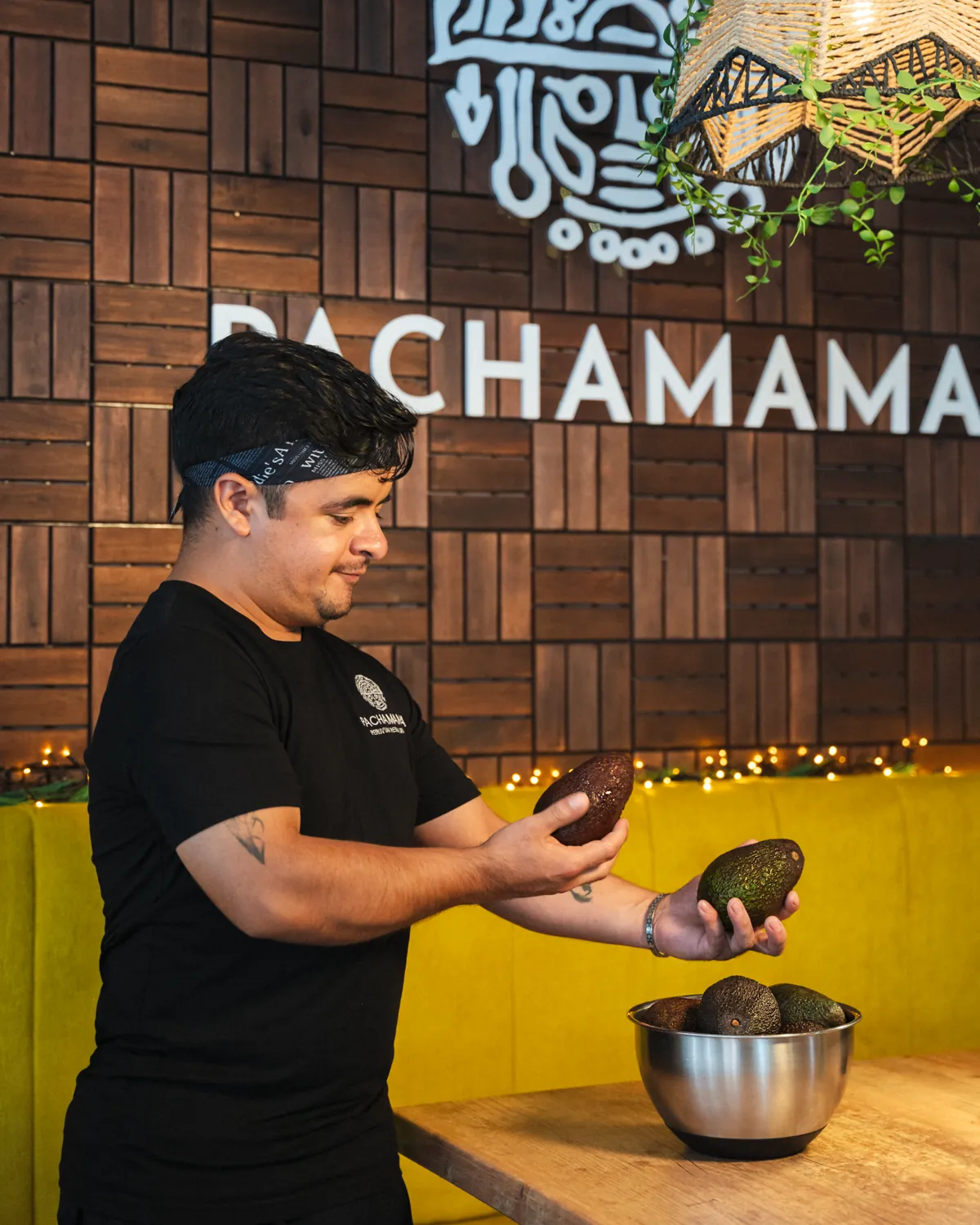 A Pachamama chef checking avocados before service