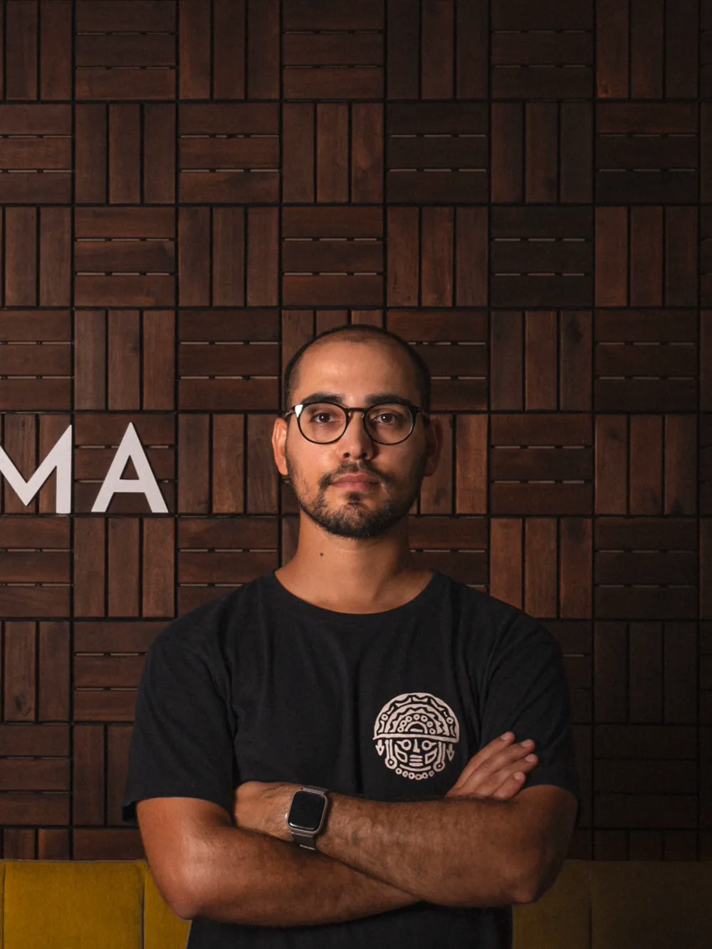 A member of the Pachamama team standing by the restaurant sign