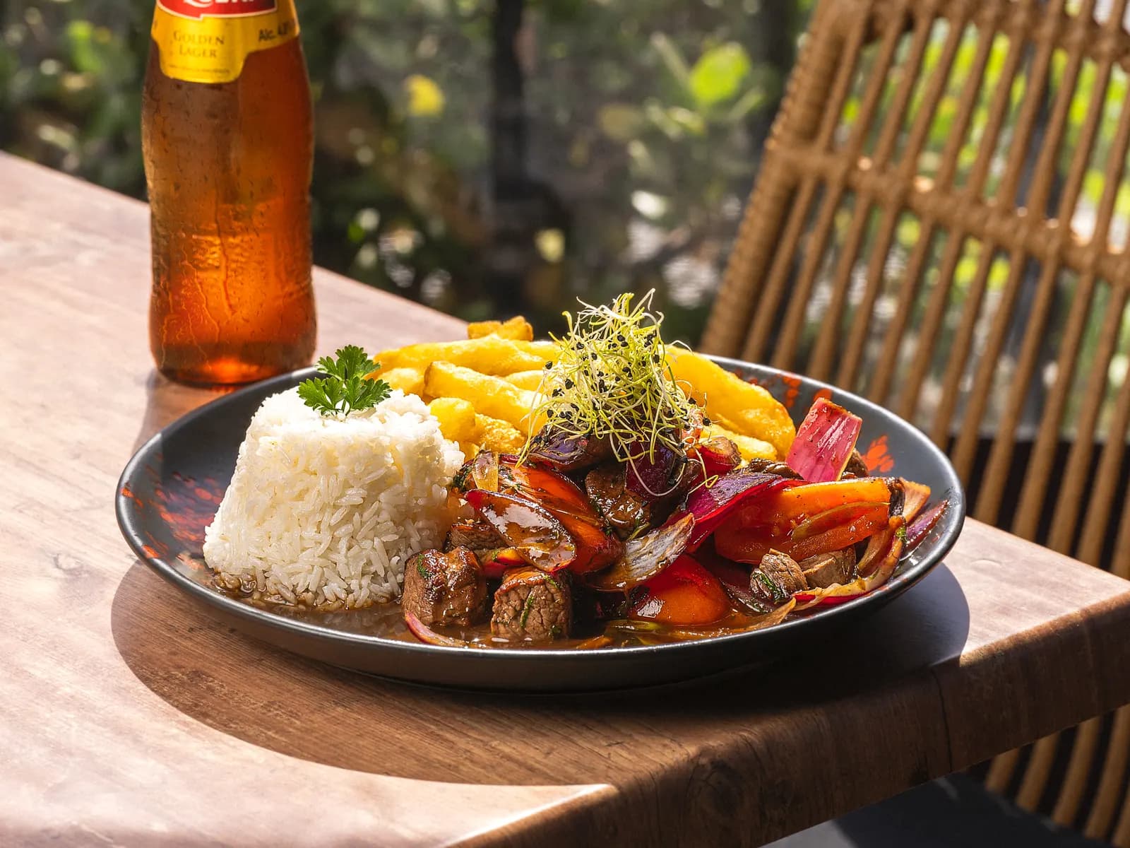 Lomo saltado at Pachamama, served with rice and chips and a Cusqueña