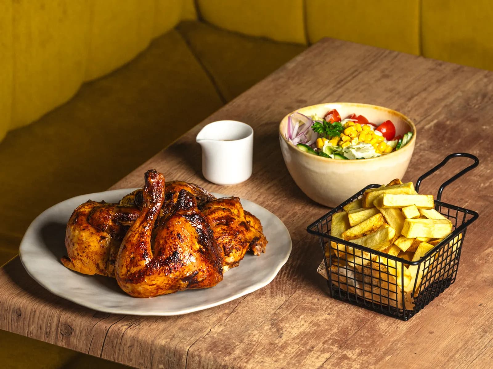 Charcoal-roasted pollo a la brasa at Pachamama with salad and chips